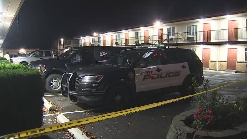 Dozens of evidence markers are strewn around the scene of an incident at a Kent motel.