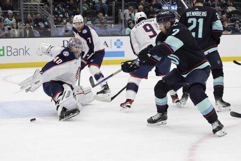Seattle Kraken right wing Jordan Eberle, front right, sends the puck past Columbus Blue Jackets goaltender Daniil Tarasov (40) for a goal during the first period of an NHL hockey game, Sunday, Jan. 28, 2024, in Seattle. The goal was Everle's second of the period. (AP Photo/John Froschauer)
