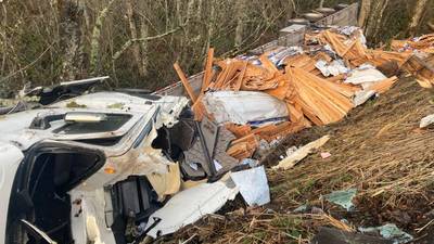 PHOTOS: Semi carrying thousands of fence boards rolls over near Eatonville