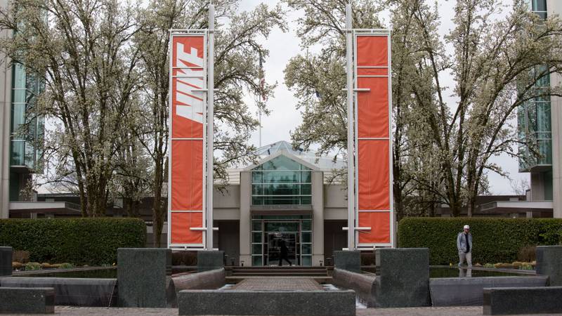 Orange banners with Nike written on them in front of the company's headquarters in Beaverton, Oregon.