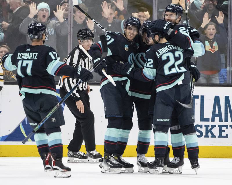 Seattle Kraken, including forward Jaden Schwartz, left, defenseman Jamie Oleksiak, far right, forward Oliver Bjorkstrand, second from right, and forward Alex Wennberg, third from left, celebrate a goal during the third period of an NHL hockey game, Monday, Feb. 26, 2024, in Seattle. The Kraken won 4-3 in a shootout.