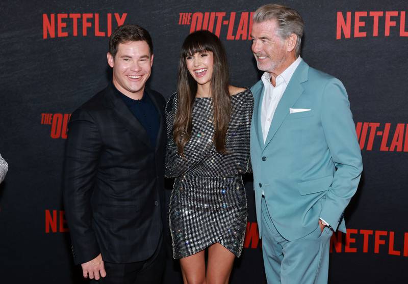 LOS ANGELES, CALIFORNIA - JUNE 26: (L-R) Adam DeVine, Nina Dobrev and Pierce Brosnan attend the Los Angeles Premiere Of Netflix's "The Out-Laws" at Regal LA Live on June 26, 2023 in Los Angeles, California. (Photo by Matt Winkelmeyer/Getty Images)