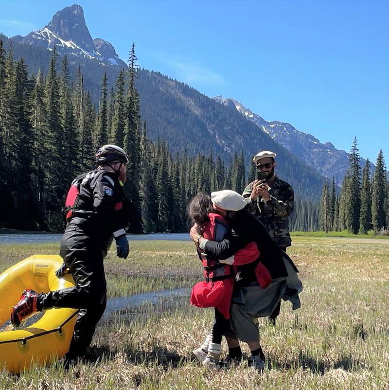 The family of a missing 10-year-old embraces her after she's returned by rescued crews near the Cle Elum River.