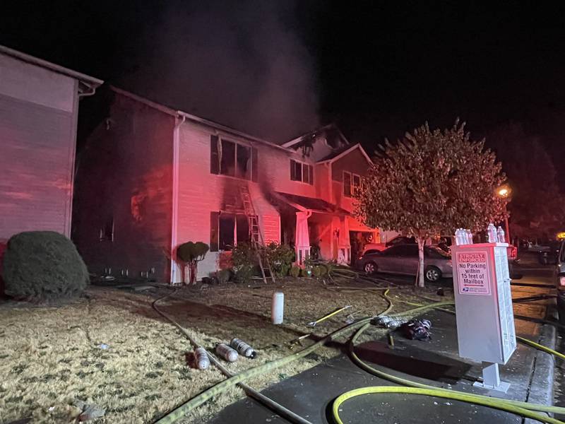 The intense radiant heat from the fire caused damage to the homes on either side.