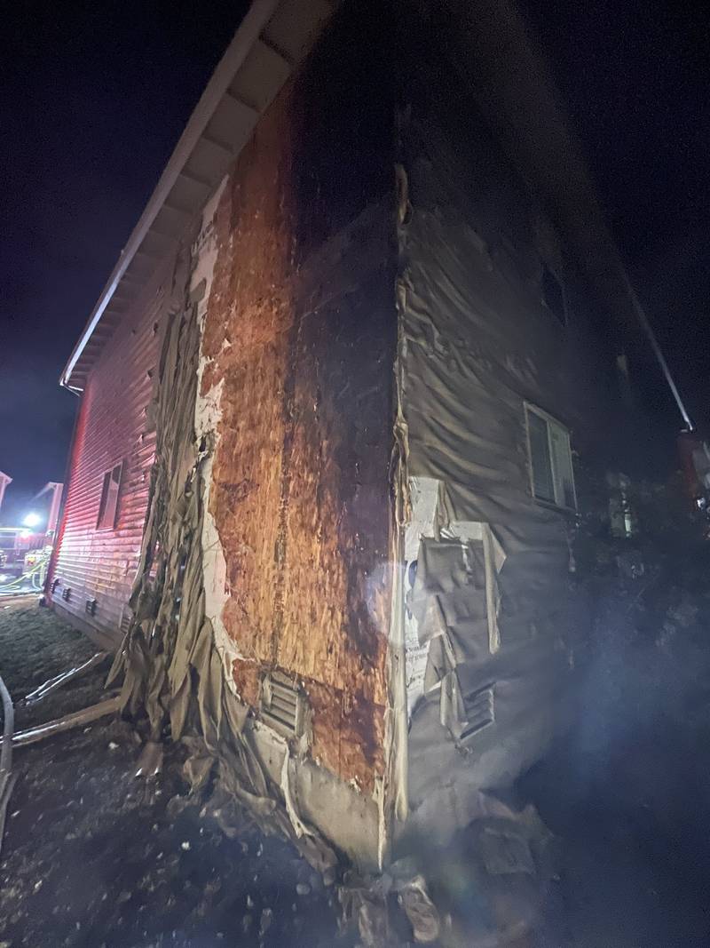 The intense radiant heat from the fire caused damage to the homes on either side.