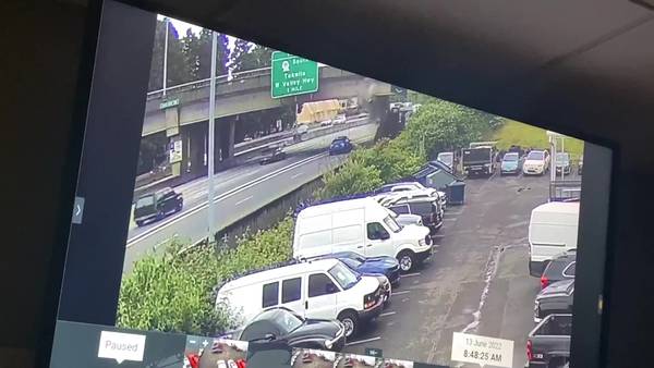 RAW: Truck with backhoe strikes 405 overpass in Renton