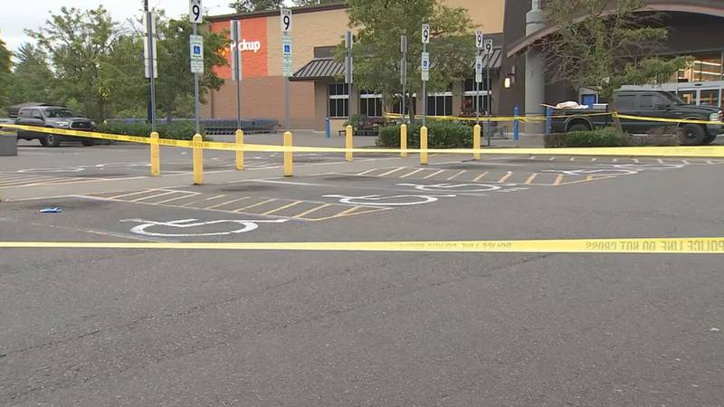 A woman shot at two suspects who tried to rob her while she sat in her car outside the Auburn Walmart.