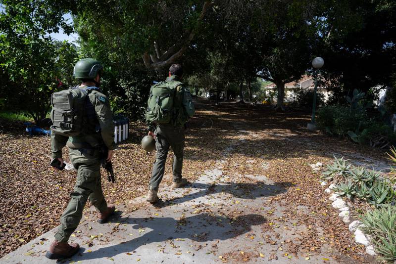 NIR YITZHAK, ISRAEL - OCTOBER 25: Soldiers walk through this kibbutz after Hamas militants shot at and killed civilians, as well as kidnapping them in homes two weeks earlier near the border with Gaza on October 25, 2023 in Nir Yitzhak, Israel. In the wake of the Oct. 7 attacks by Hamas that left an estimated 1,400 dead and 200 kidnapped, Israel launched a sustained bombardment of the Gaza Strip and threatened a ground invasion to vanquish the militant group that governs the Palestinian territory. But the fate of the hostages, Israelis and foreign nationals who are being held by Hamas in Gaza, as well as international pressure over the humanitarian situation in Gaza, have complicated Israel's military response to the attacks. A timeline for a proposed ground invasion remains unclear. (Photo by Alexi J. Rosenfeld/Getty Images)