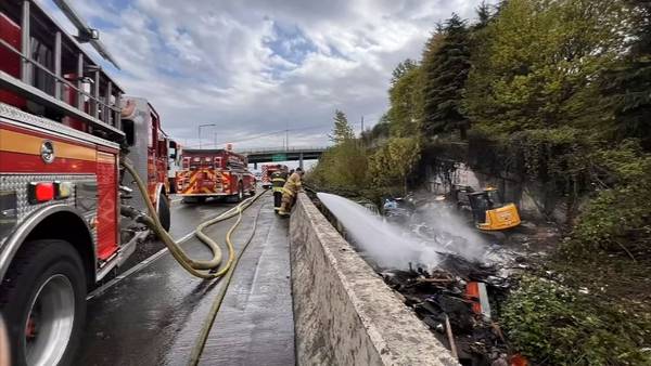 Encampment fire that spread to brush jams traffic on eastbound I-90 in Seattle