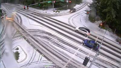 Western Washington hit with light snow overnight, leading to icy roads, flight delays
