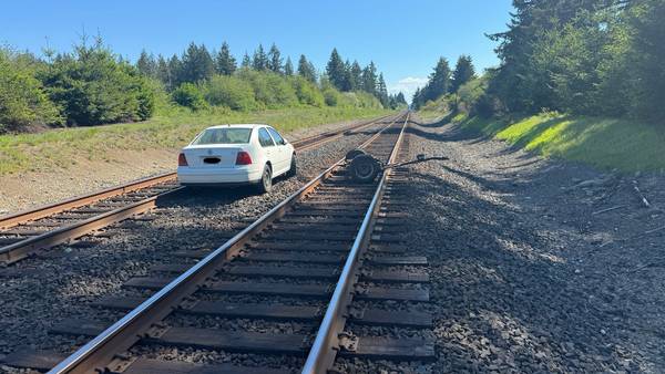 Abandoned car left on railroad tracks in Olympia