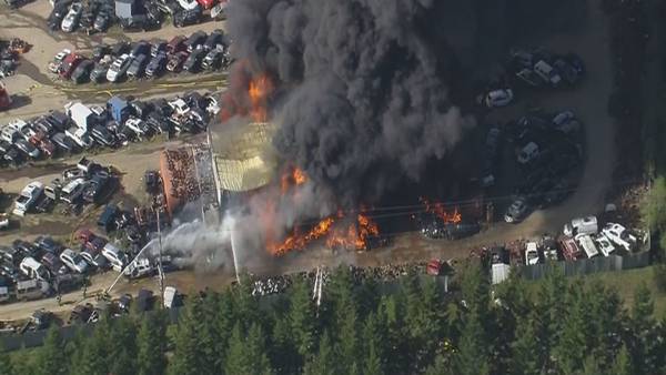 Large fire burns at auto salvage yard in Grapeview