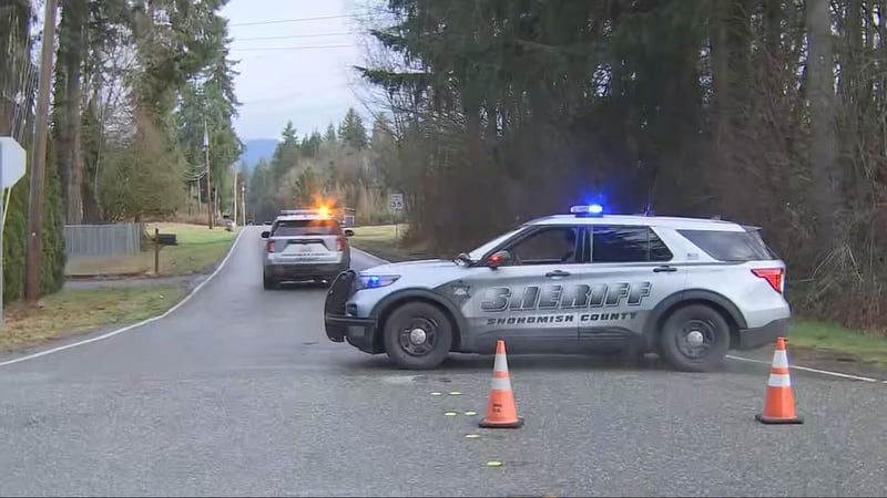 Snohomish County Sheriff's Office vehicles block the road during a standoff in Arlington Thursday.
