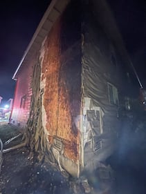 The intense radiant heat from the fire caused damage to the homes on either side.