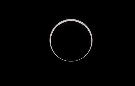 CAPITOL REEF NATIONAL PARK, UTAH - OCTOBER 14:  The moon crosses the sun as it exits the maximum eclipse during the Annular Solar Eclipse  on October 14, 2023 in Capitol Reef National Park, Utah. Starting at the Oregon coast and concluding on the east coast of South America an annular solar eclipse, where the moon is at its farthest from the Earth, will project a halo of sunlight around the moon's border.  (Photo by George Frey/Getty Images)