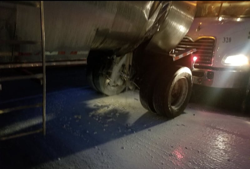 One semi truck had a load of milk or cream, which spilled onto the freeway.