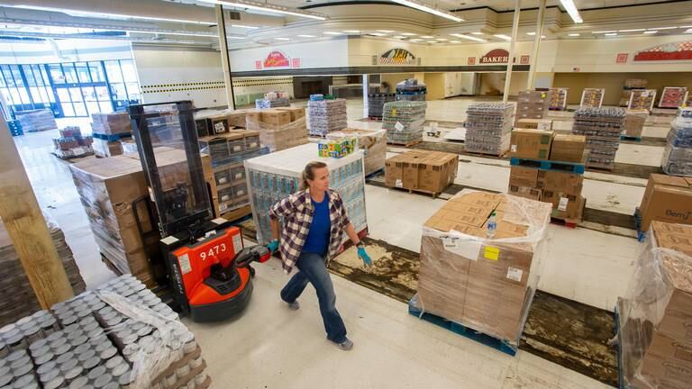 Warehouse manager Autumn Majack moves pallets of food on Wednesday, April 29, 2020 in the Puyallup Food Bank’s new temporary location in the old Safeway at Valley Plaza.