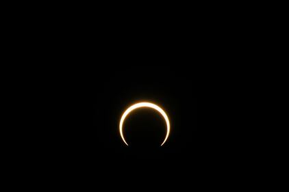 KERRVILLE, TEXAS - OCTOBER 14: The moon begins to fall below the sun's horizon during an annular solar eclipse on October 14, 2023 in Kerrville, Texas. Differing from a total solar eclipse, the moon in an annular solar eclipse covers part of the sun's light, creating the "ring of fire" effect around the moon. (Photo by Brandon Bell/Getty Images)