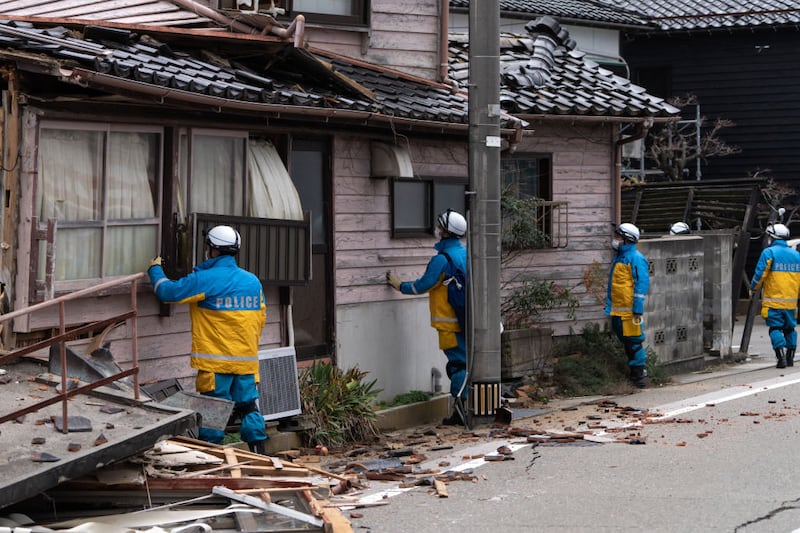 WAJIMA, JAPAN - JANUARY 05: Police officers search for survivors in the aftermath of an earthquake on New Year's Day on January 05, 2024 in Wajima, Japan. A series of major earthquakes have reportedly killed at least 92 people, injured dozens more and destroyed a large amount of homes. The earthquakes, the biggest measuring 7.1 magnitude, hit the areas around Ishikawa, Toyama and Niigata in central Japan on Monday. (Photo by Tomohiro Ohsumi/Getty Images)