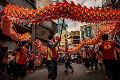 MANILA, PHILIPPINES - FEBRUARY 10: Dragon dancers perform during Lunar New Year celebrations at Binondo district, considered the world's oldest Chinatown, on February 10, 2024 in Manila, Philippines. Lunar New Year, also known as Chinese New Year, is celebrated around the world, and the year of the Wood Dragon in 2024 is associated with growth, progress, and abundance, as wood represents vitality and creativity, while the dragon symbolizes success, intelligence, and honor. (Photo by Ezra Acayan/Getty Images)