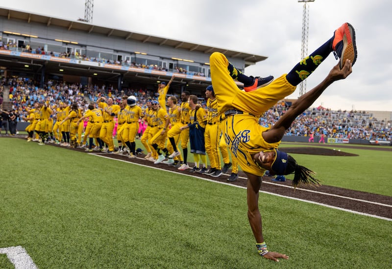 NEW YORK, NEW YORK - AUGUST 12:  First Base Coach/Dance instructor Maceo Harrison of the Savannah Bananas performs a dance routine their game against the Party Animals at Richmond County Bank Ball Park on August 12, 2023 in New York City.  The Savannah Bananas were part of the Coastal Plain League, a summer collegiate league, for seven seasons. In 2022, the Bananas announced that they were leaving the Coastal Plain League to play Banana Ball year-round. Banana Ball was born out of the idea of making baseball more fast-paced, entertaining, and fun.   (Photo by Al Bello/Getty Images)