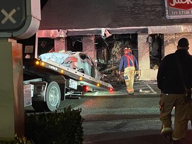 A Federal Way Jack in the Box is in shambles after a car slammed into the side of the restaurant and burst into flames.