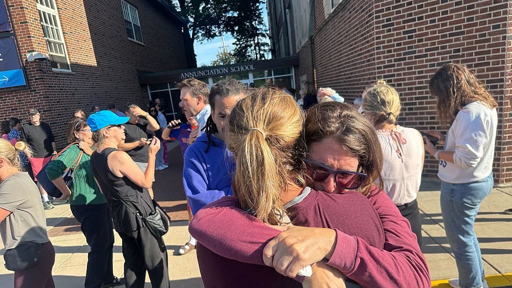 Parents hug after a school shooting in Minneapolis