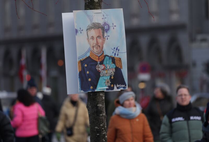 COPENHAGEN, DENMARK - JANUARY 14: People walk past a poster that shows Crown Prince Frederik prior to his proclamation as new Danish King Frederik X on January 14, 2024 in Copenhagen, Denmark. King Frederik X is succeeding Queen Margrethe II, who is stepping down after reigning for 51 years. (Photo by Sean Gallup/Getty Images)