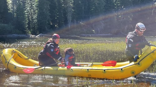 Crews in an inflatable raft bringing a lost 10-year-old back to her family