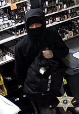 The workers were held at gunpoint while the other two suspects filled their backpacks with about $5,620 worth of marijuana products and about $4,500 in cash.