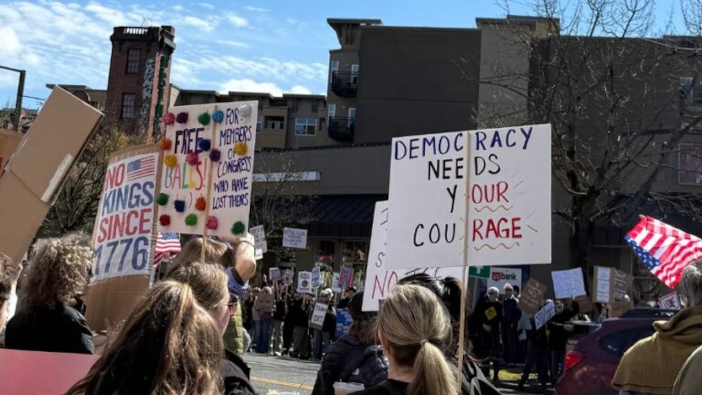 Participants hold signs during a smaller rally in Seattle’s Ballard neighborhood. (Photo: Frank Sumrall, MyNorthwest)