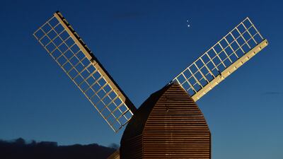 Jupiter and Saturn are seen coming together in the night sky, over the sails of Brill windmill, for what is known as the Great Conjunction, on December 20, 2020, in Brill, England.