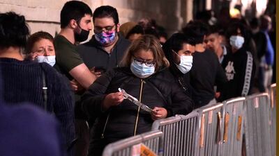 Black Friday shoppers wait in line to enter an electronics store that opened at 5am in the Dallas suburb of Frisco, Texas, Friday, Nov. 27, 2020.