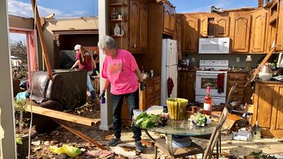 Patti Herring sobs as she sorts through the remains of her home in Fultondale, Ala., on Tuesday, Jan. 26, 2021, after it was destroyed by a tornado.
