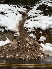 A rockslide blocking White Pass west of the summit at milepost 144 left a large boulder exposed about 125 feet above the highway.