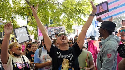 Britney Spears supporter Brian Molina of Los Angeles celebrates outside the Stanley Mosk Courthouse, Wednesday, Sept. 29, 2021, in Los Angeles. A judge on Wednesday suspended Britney Spears' father from the conservatorship that has controlled the singer's life and money for 13 years, saying the arrangement "reflects a toxic environment."