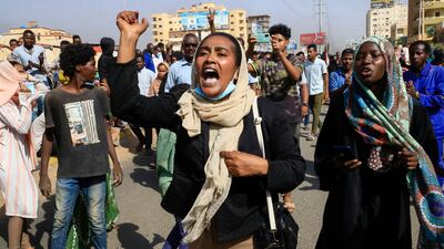 Sudanese protesters march in 60th Street in the capital Khartoum to denounce overnight detentions by the army of members of Sudan's government, on October 25, 2021.
