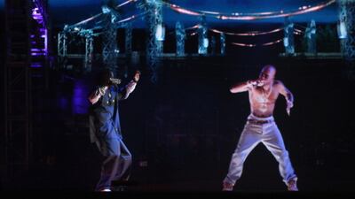 INDIO, CA - APRIL 15: Rapper Snoop Dogg (L) and a hologram of deceased Tupac Shakur perform onstage during day 3 of the 2012 Coachella Valley Music & Arts Festival at the Empire Polo Field on April 15, 2012 in Indio, California. (Photo by Christopher Polk/Getty Images for Coachella)