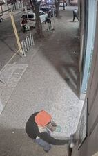 This image provided by Multnomah County shows  video surveillance of a group of hooded and masked people breaking windows and spray painting anti-government graffiti on the Multnomah County Elections building on Monday, Jan. 20, 2025 in Portland, Ore.  (Multnomah County via AP)
