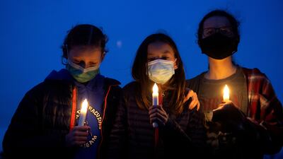 People gather for a candlelight vigil on March 23, 2021, to honor the ten victims of a mass shooting that occurred a day earlier at a King Soopers grocery store in Boulder, Colorado.