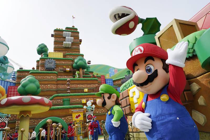 The Nintendo video game characters "Mario," right, and "Luigi" stand in the main plaza of the new Universal Studios Hollywood attraction Super Nintendo World during a preview day, Thursday, Feb. 16, 2023, in Universal City, Calif. The attraction opens to the public Friday.