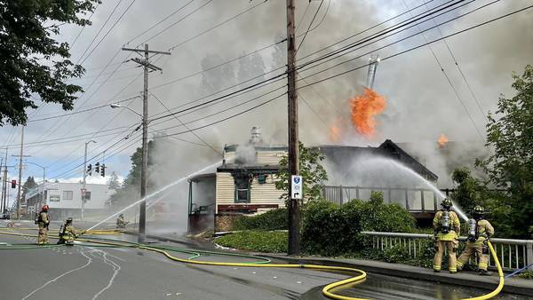 Flames shoot high into the sky as an abandoned restaurant burns in Tumwater