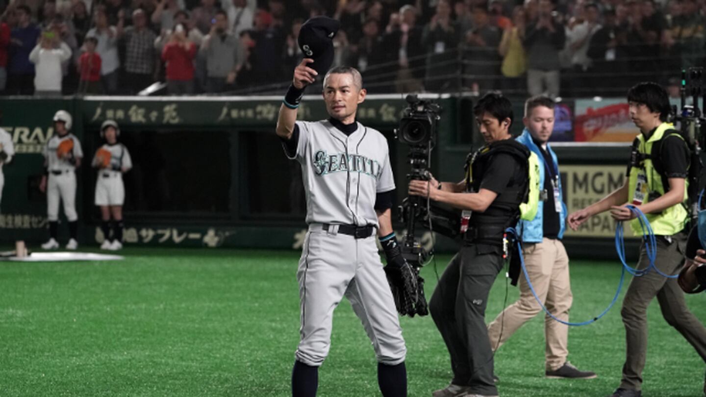 Former Seattle Mariners player Ichiro Suzuki poses with the trophy during a  ceremony honoring Suzuki with the franchise achievement award before the  Major League Baseball game at T-Mobile Park on September 14